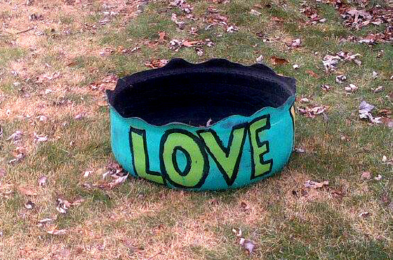 a dog bed with the word love painted on it