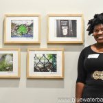 a woman standing in front of four framed pictures