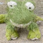 a stuffed animal made to look like a frog