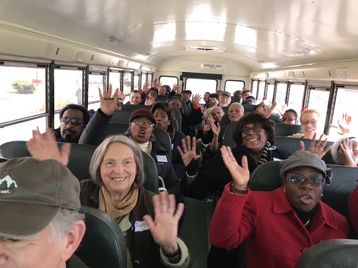 a group of people on a bus waving