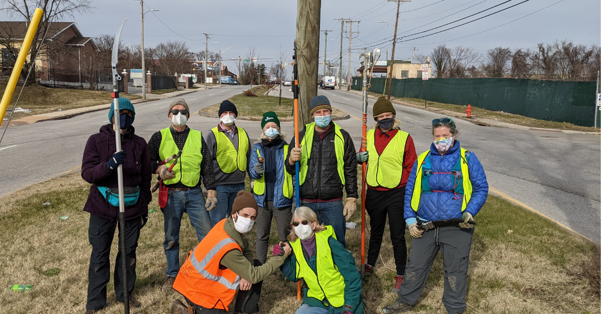 a group of people wearing face masks and vests