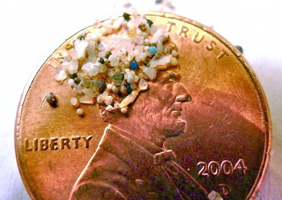 In this photo provided by 5gyres.org is a sample showing the tiny bits of microbead plastic on a penny. These fine powders, making their way into our waters, are typically made from synthetic polymers such as polyethylene, polypropylene or polytetrafluoroethylene.