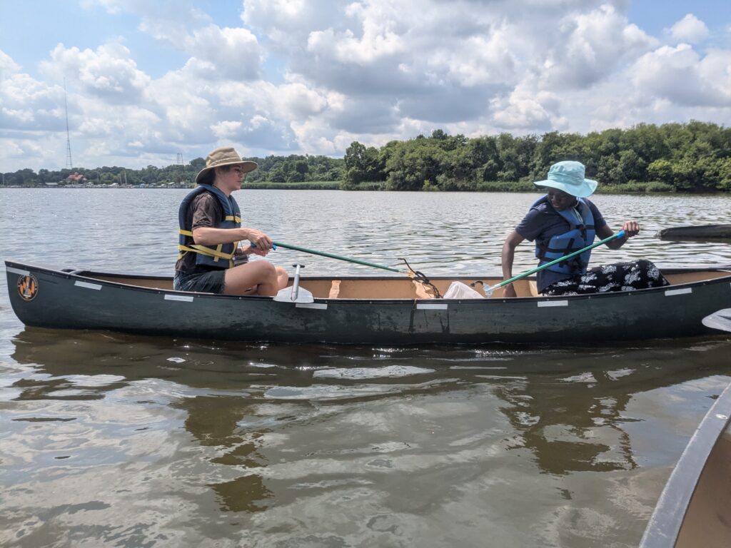 two people in a canoe on a lake