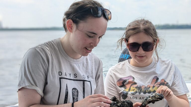 a couple of people standing on a boat