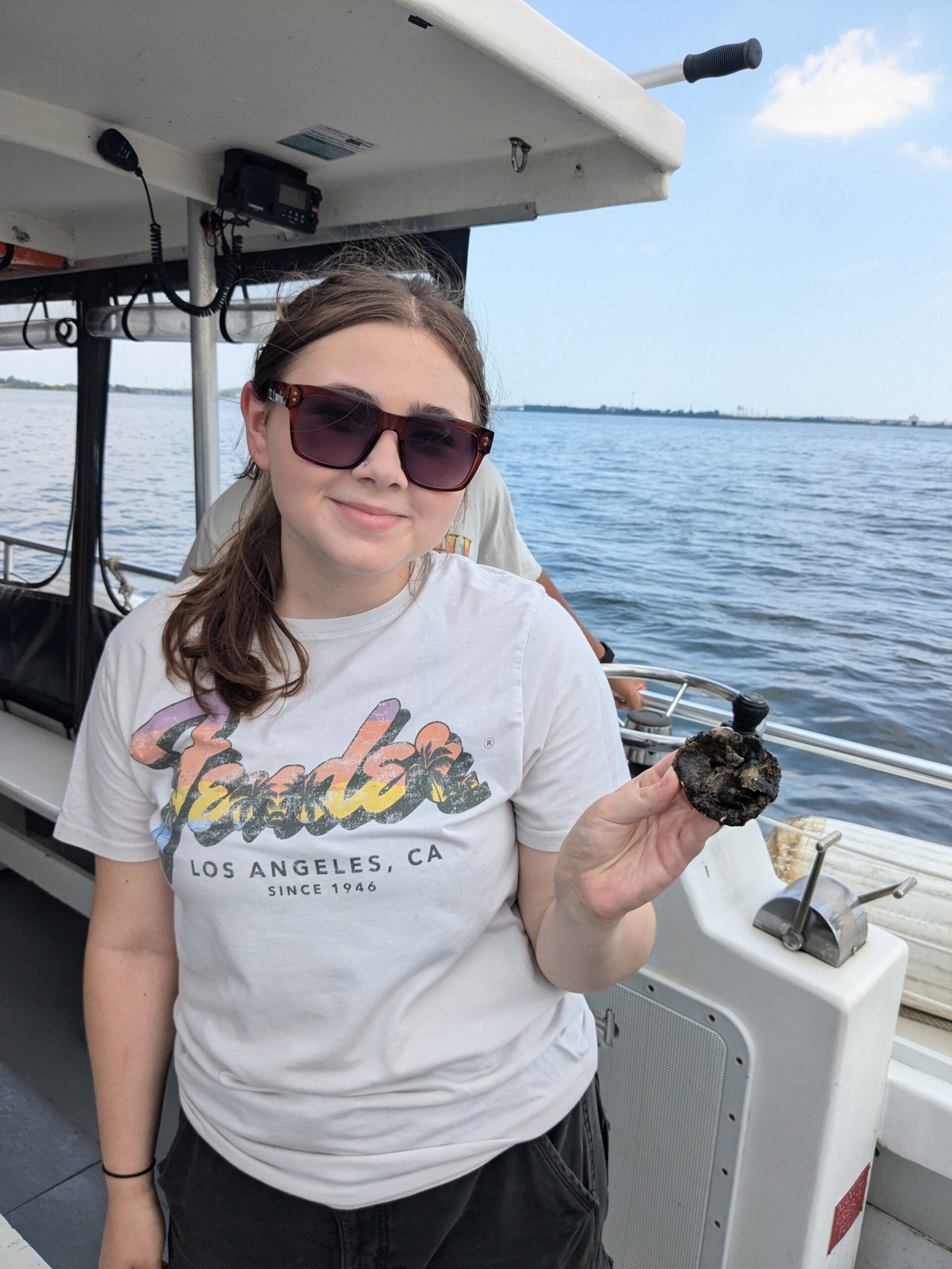 a woman holding a crab on a boat