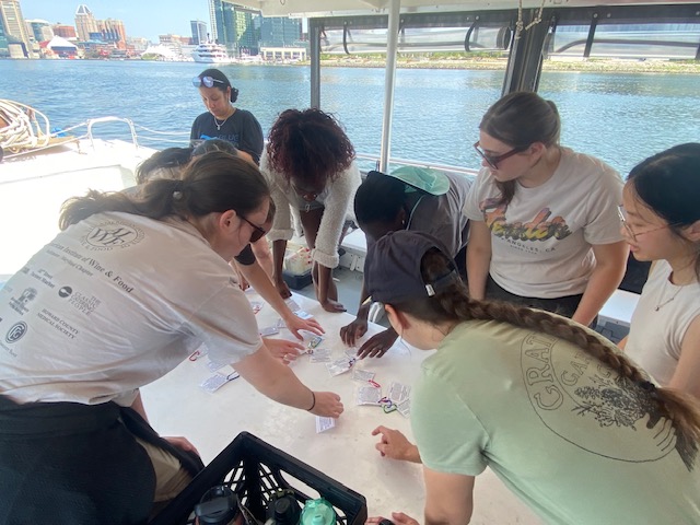 a group of people standing around a table