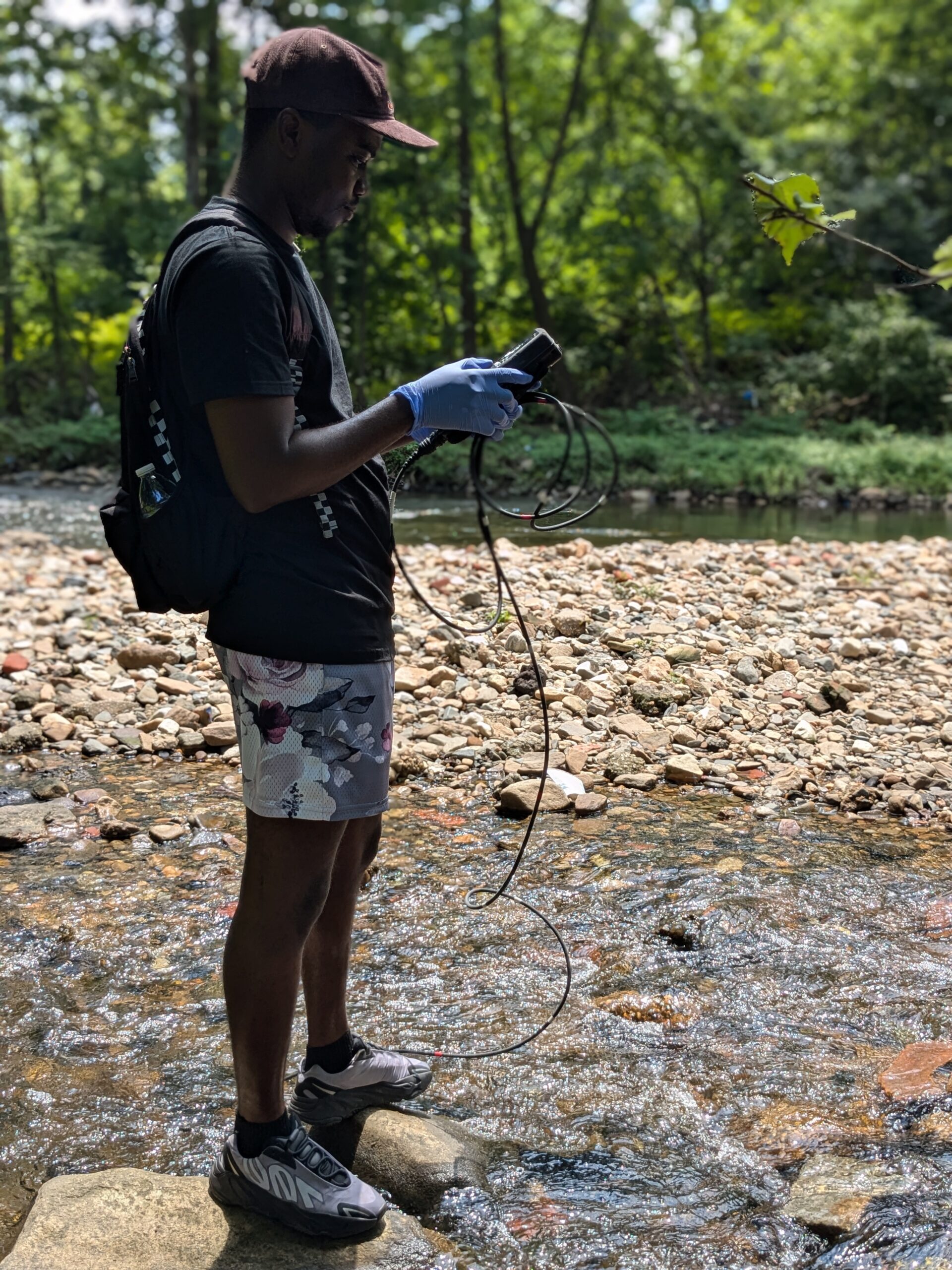 a man standing on a rock in the middle of a river