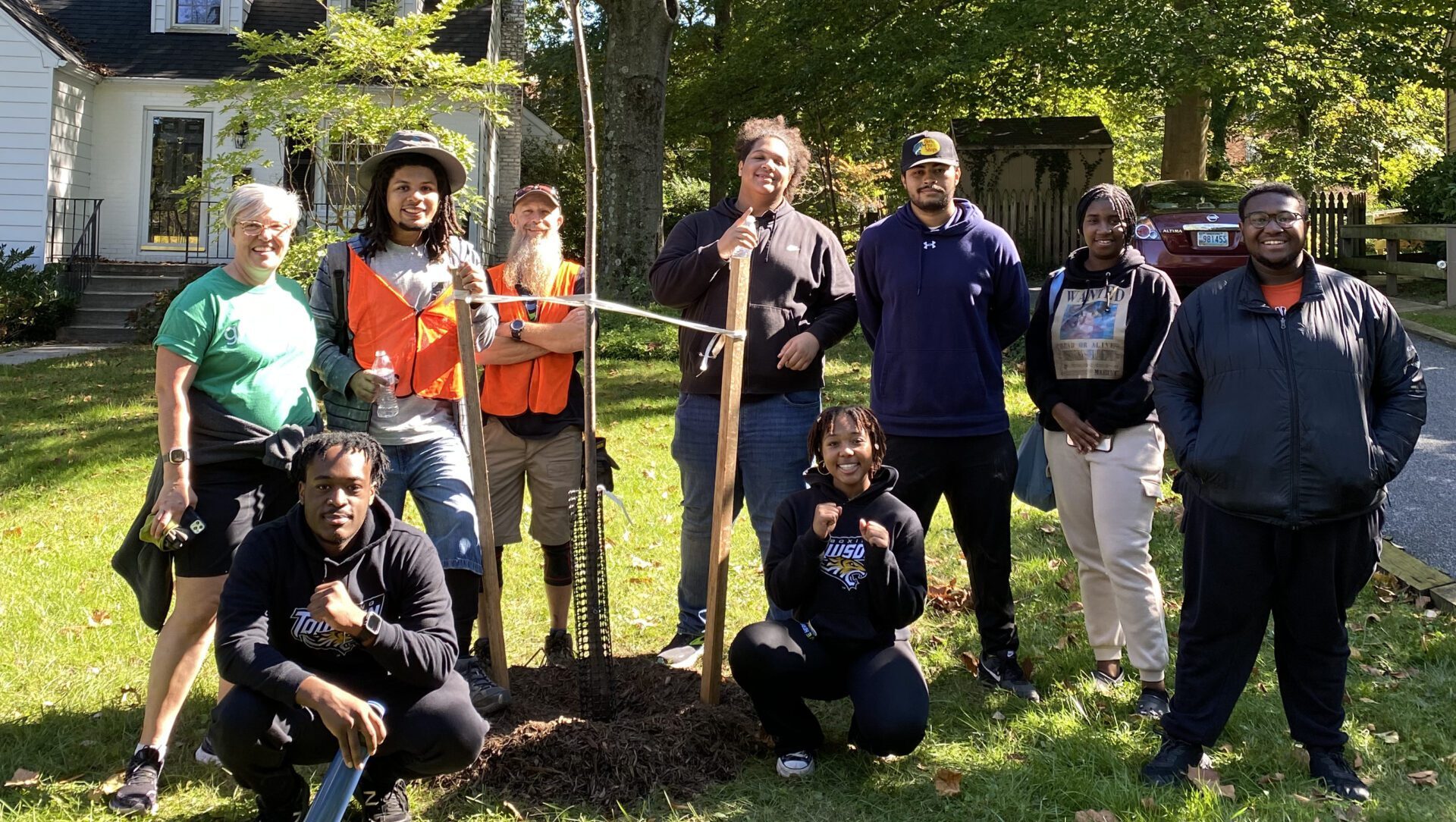 a group of people standing around a tree