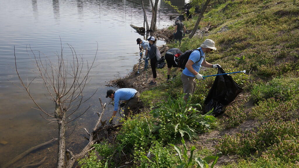a group of people standing next to a river
