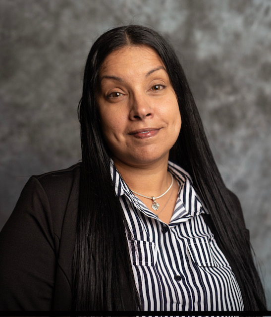 a woman with long black hair is posing for a picture